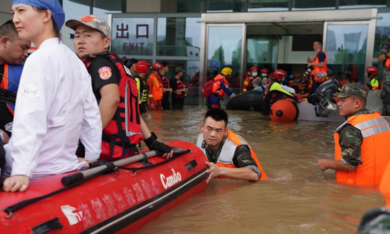 Rescuers help people to evacuate at the outpatient department of the Fuwai Central China Cardiovascular Hospital in Zhongmu County of Zhengzhou, central China's Henan Province, July 22, 2021.Photo:Xinhua