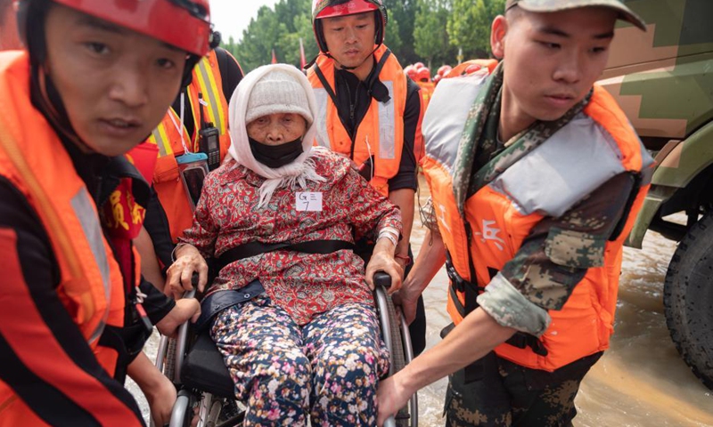 Rescuers help a senior patient to evacuate near the Fuwai Central China Cardiovascular Hospital in Zhongmu County of Zhengzhou, central China's Henan Province, July 22, 2021.Photo:Xinhua