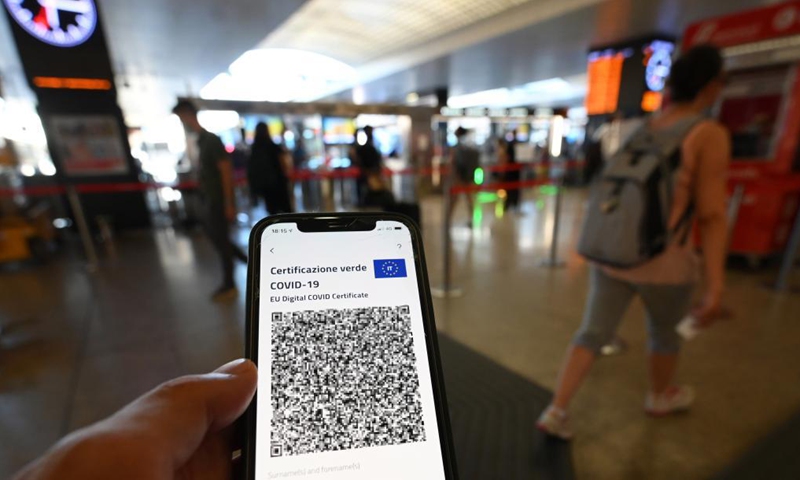 A passenger holds a cellphone displaying COVID Green Pass QR code in Rome, Italy, on July 20, 2021. The COVID Green Pass will be mandatory to enter restaurants, cafes and other eateries in Italy starting from Aug. 6, the government announced Thursday.Photo:Xinhua