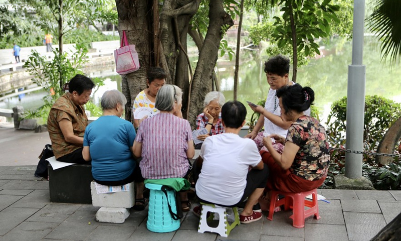 People play poker in Pantangwuyue historical community in Liwan District of Guangzhou, south China's Guangdong Province, July 16, 2021.Photo:Xinhua