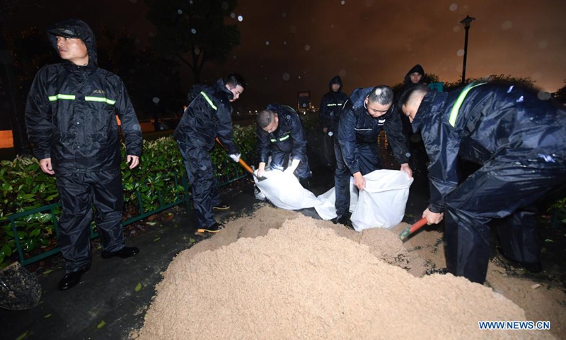 Staff pile sandbags to prevent flood at a park in Pinghu, Jiaxing, east China's Zhejiang Province, July 25, 2021. China's national observatory on Sunday continued its orange alert for Typhoon In-Fa, which made landfall in Zhejiang at around Sunday noon. Moving northwestward at about 10 km per hour, In-Fa will make another landfall in coastal areas from Pinghu in Zhejiang Province to Pudong in Shanghai, according to the National Meteorological Center. (Xinhua)