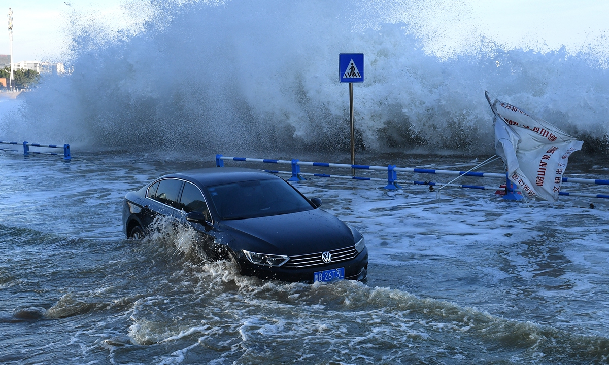 Waves of up to 10 meters crash against the shore in the port city of Qingdao, Shandong Province as Typhoon In-Fa churns up the east coast of China on Sunday. Typhoon In-Fa, the strongest so far in 2021, has seen eastern China bracing for strong rain, winds and storm tides after it made landfall on the coast of Zhoushan, Zhejiang Province on Sunday. (See story on Page-4) Photo: AFP