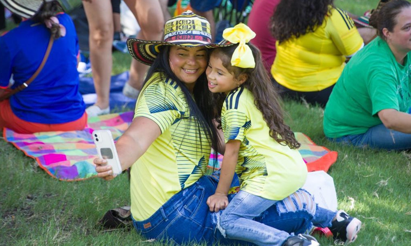 People take selfie at the Dallas Colombian Festival in Dallas, the United States, on July 24, 2021. (Photo by Dan Tian/Xinhua)