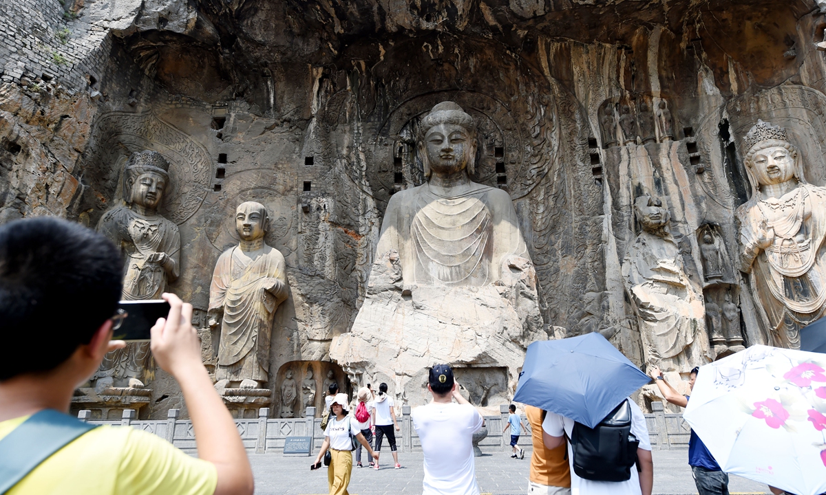 Tourists visit the Longmen Grottoes in Luoyang, Central China's Henan Province on Monday. Day tours of the grottoes officially resumed on Monday. Since the temporary closure on July 20 due to heavy rain, the scenic spot has completed safety inspections of heritage relics and repairs of service facilities and equipment. Photo: VCG.