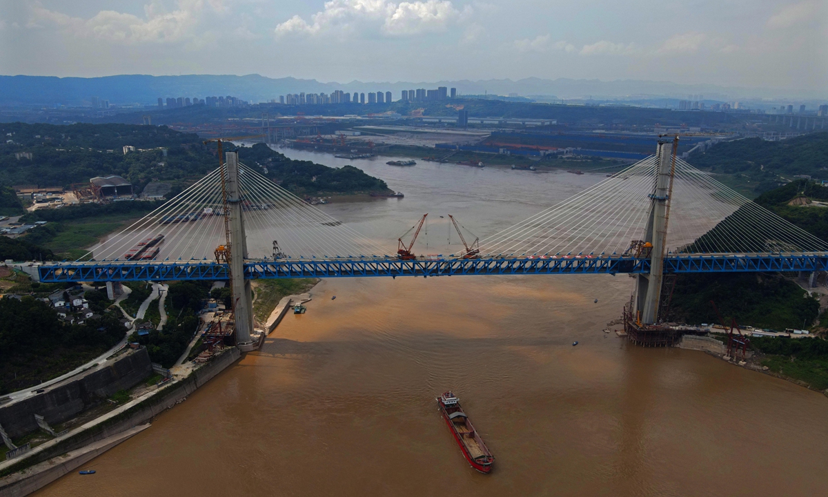 Construction finishes on the Mingyue Gorge Yangtze River Bridge and both ends are joined on Tuesday in Southwest China's Chongqing Municipality. The span is a double-deck, railway asymmetric cable-stayed bridge, with a total length of 877.8 meters. The upper deck  is reserved for high-speed trains, and the lower one  is for passenger and freight trains. Photo: IC