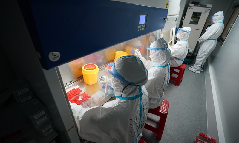 Staff members work in a temporary laboratory for nucleic acid testing at the square of the Nanjing Railway Station in Nanjing, capital of east China's Jiangsu Province, July 27, 2021.(Photo: Xinhua)