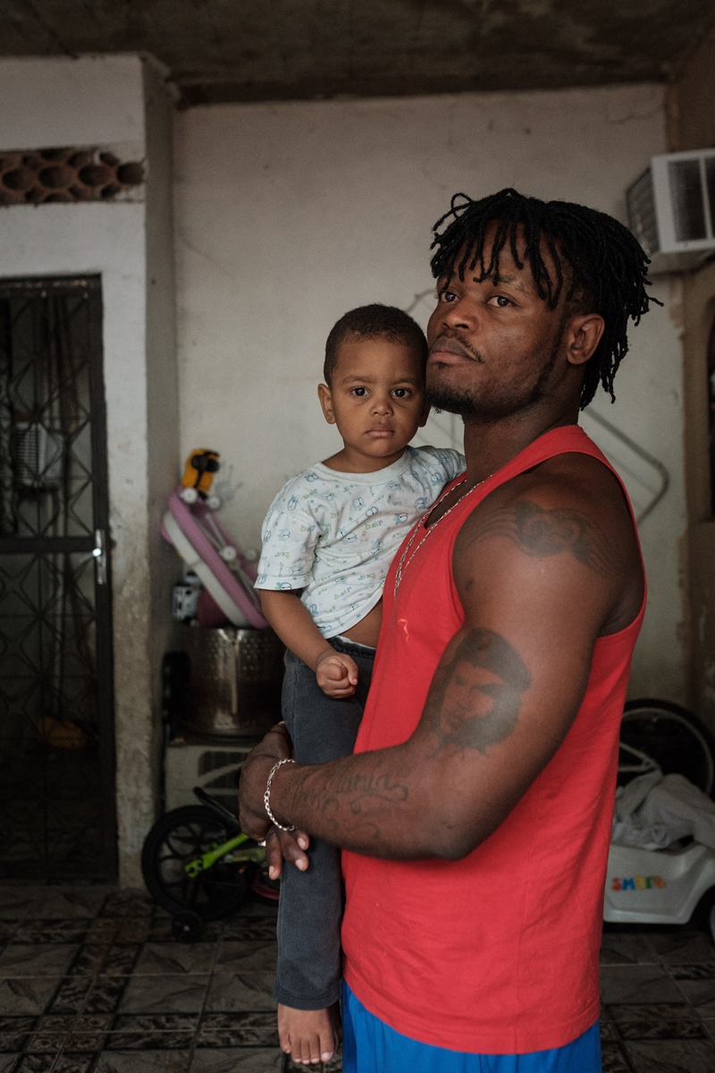 Popole Misenga holds his 2-year-old son Helias at his home in Rio de Janeiro, Brazil, on June 21, 2017. Photo: AFP