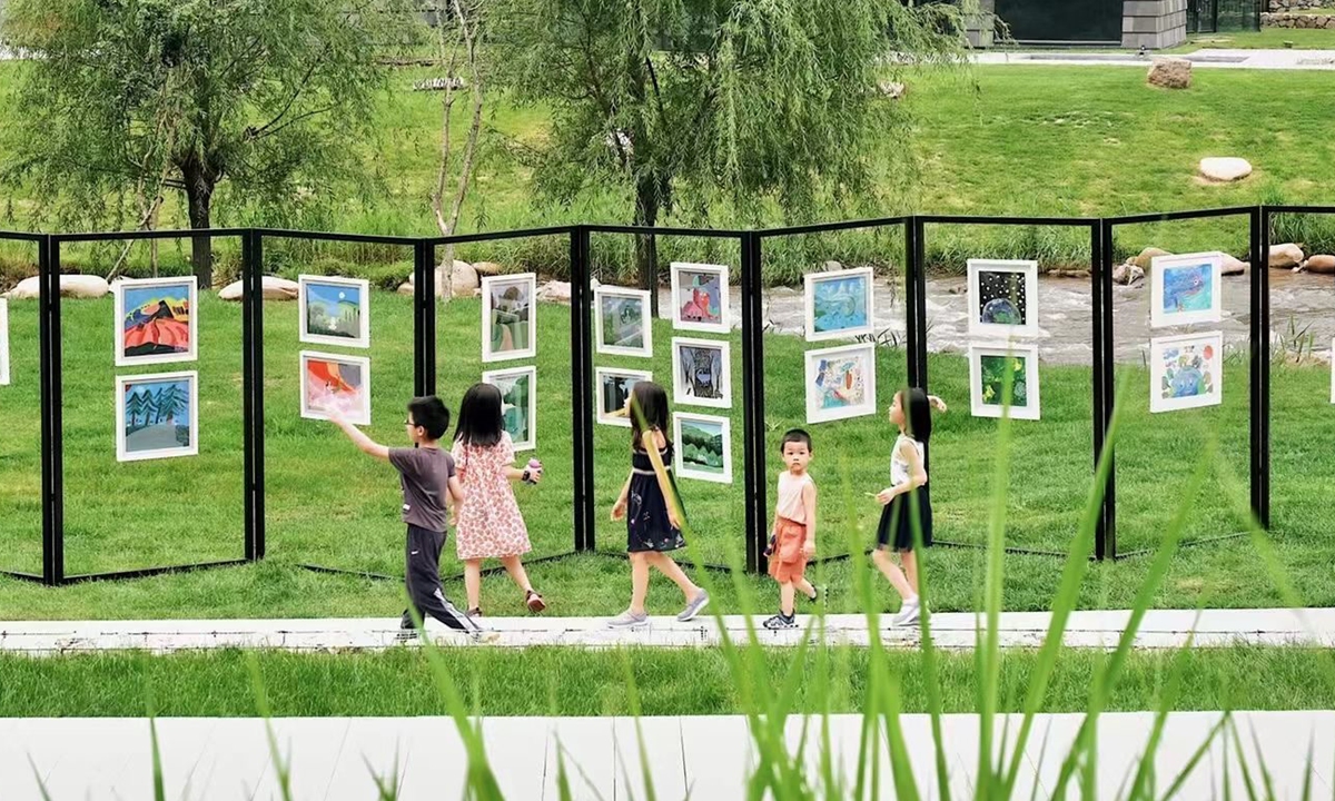 Children walk past their paintings at Rehe Valley, Chengde in North China's Hebei Province. Photo: Courtesy of Zhao Mengyuan