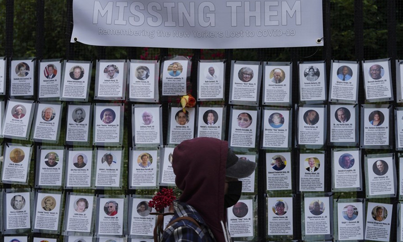 A pedestrian walks past a memorial installation for those who died of COVID-19 outside Green-Wood Cemetery in New York, the United States, on June 14, 2021.Photo:Xinhua