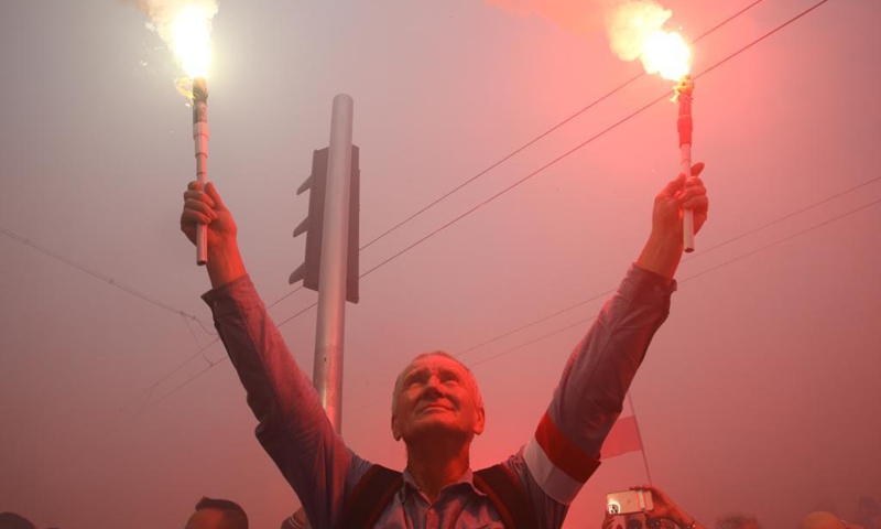People gather to commemorate the Warsaw Uprising in Warsaw, Poland, on Aug. 1, 2021. On Aug. 1, 1944, the Polish underground resistance, led by the Polish Home Army, began a major military operation to liberate Warsaw from Nazi occupation. The uprising, which lasted 63 days, was the largest military effort of any European resistance against Nazi Germany. (Photo by Jaap Arriens/Xinhua)