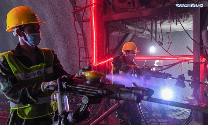 Staff members work inside the Deqing tunnel of the Guiyang-Nanning high-speed railway in Hechi, south China's Guangxi Zhuang Autonomous Region, Aug. 2, 2021. The 6.61-km-long Deqing tunnel was drilled through on Tuesday. It is a critical control project in the construction of the Guiyang-Nanning high-speed railway, which is expected to put into operation by the end of 2023. (Xinhua/Cao Yiming)