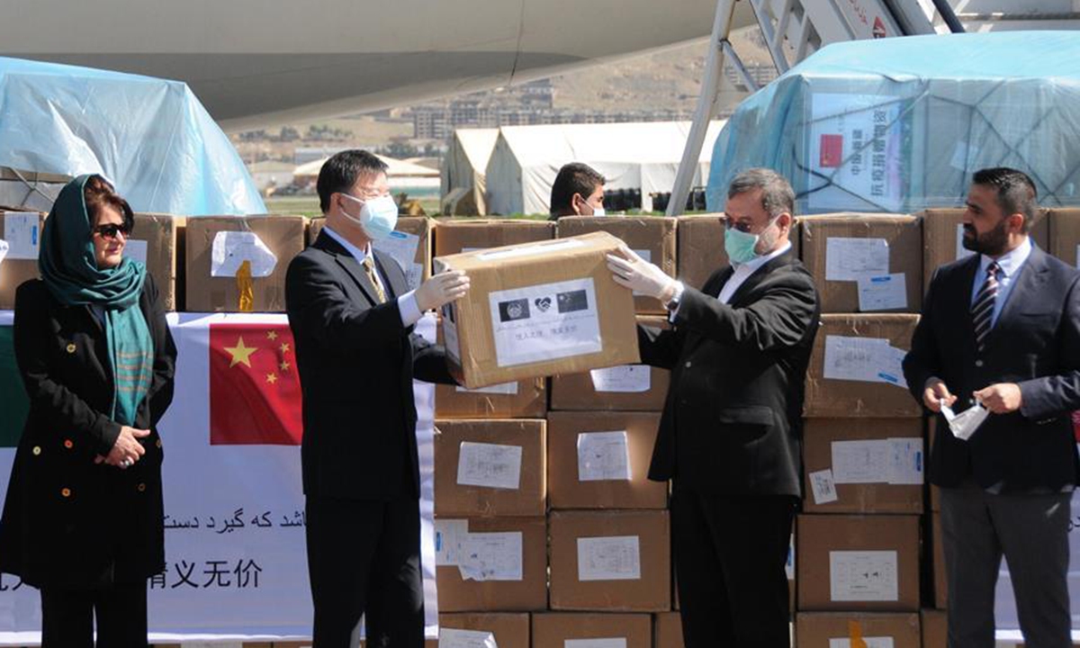 Chinese Ambassador Wang Yu (2nd L) hands over medical supplies to Mohammad Sarwar Danish, second vice president of Afghanistan, during a handover ceremony in Kabul, Afghansitan, April 2, 2020. China stands together with Afghan people to fight the novel coronavirus, Chinese Ambassador to Afghansitan Wang Yu said at a handover ceremony of the first batch of China-aided medical supplies on Thursday.  Photo: Xinhua