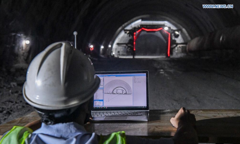 A technician uses a 3D scanner to collect data inside the Deqing tunnel of the Guiyang-Nanning high-speed railway in Hechi, south China's Guangxi Zhuang Autonomous Region, Aug. 3, 2021. The 6.61-km-long Deqing tunnel was drilled through on Tuesday. It is a critical control project in the construction of the Guiyang-Nanning high-speed railway, which is expected to put into operation by the end of 2023. (Xinhua/Cao Yiming)