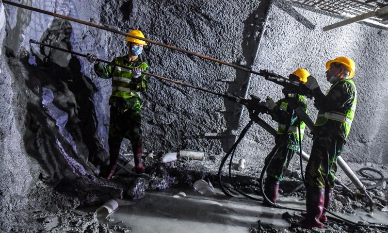 Staff members work inside the Deqing tunnel of the Guiyang-Nanning high-speed railway in Hechi, south China's Guangxi Zhuang Autonomous Region, Aug. 2, 2021. The 6.61-km-long Deqing tunnel was drilled through on Tuesday. It is a critical control project in the construction of the Guiyang-Nanning high-speed railway, which is expected to put into operation by the end of 2023. (Xinhua/Cao Yiming)
