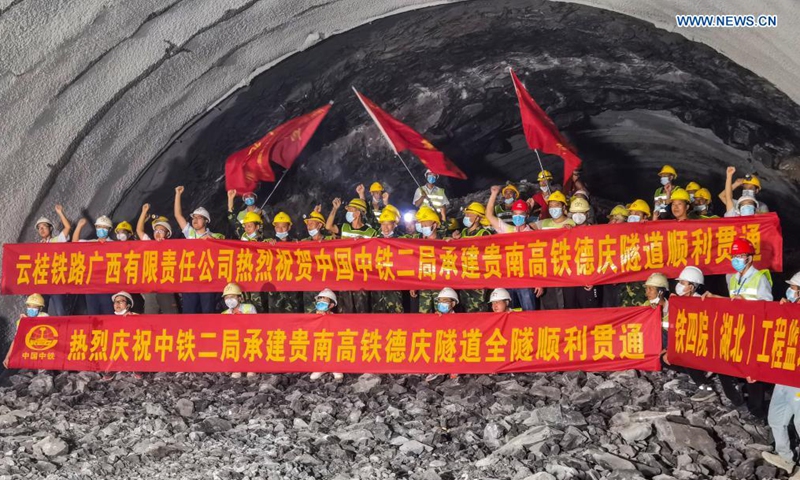Staff members work inside the Deqing tunnel of the Guiyang-Nanning high-speed railway in Hechi, south China's Guangxi Zhuang Autonomous Region, Aug. 2, 2021. The 6.61-km-long Deqing tunnel was drilled through on Tuesday. It is a critical control project in the construction of the Guiyang-Nanning high-speed railway, which is expected to put into operation by the end of 2023. (Xinhua/Liu Lingyi)