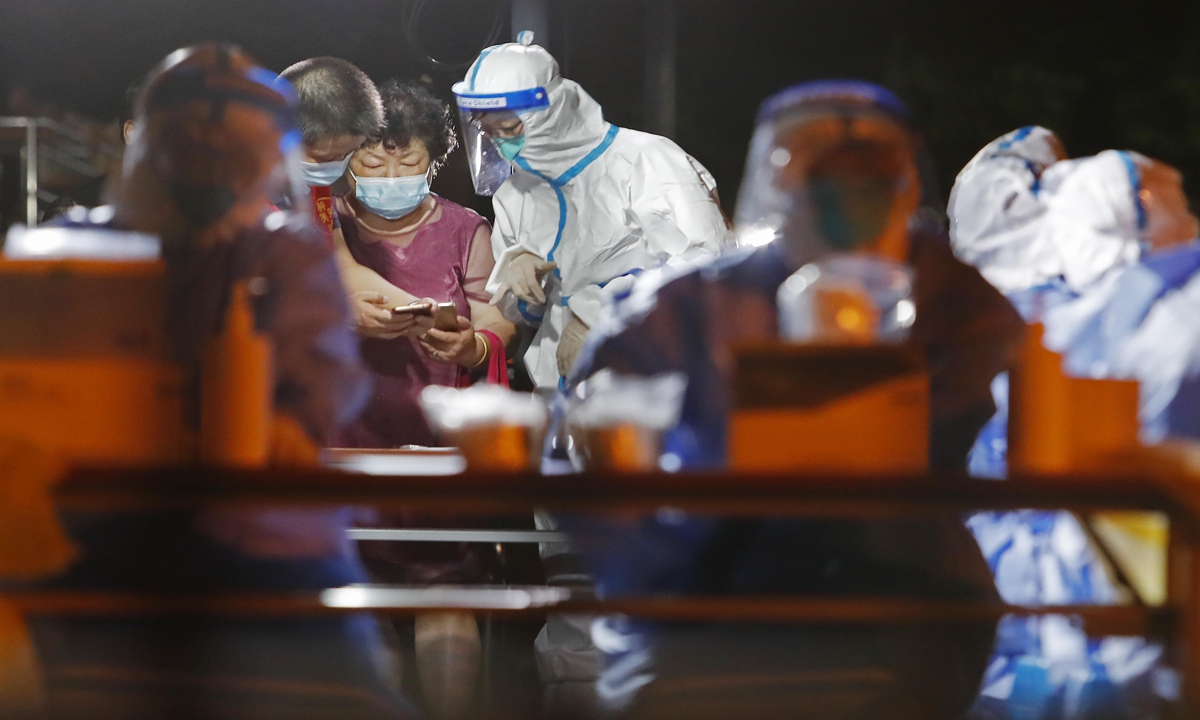 Medical staff members work at the Pudong airport on Monday night. Photo: VCG