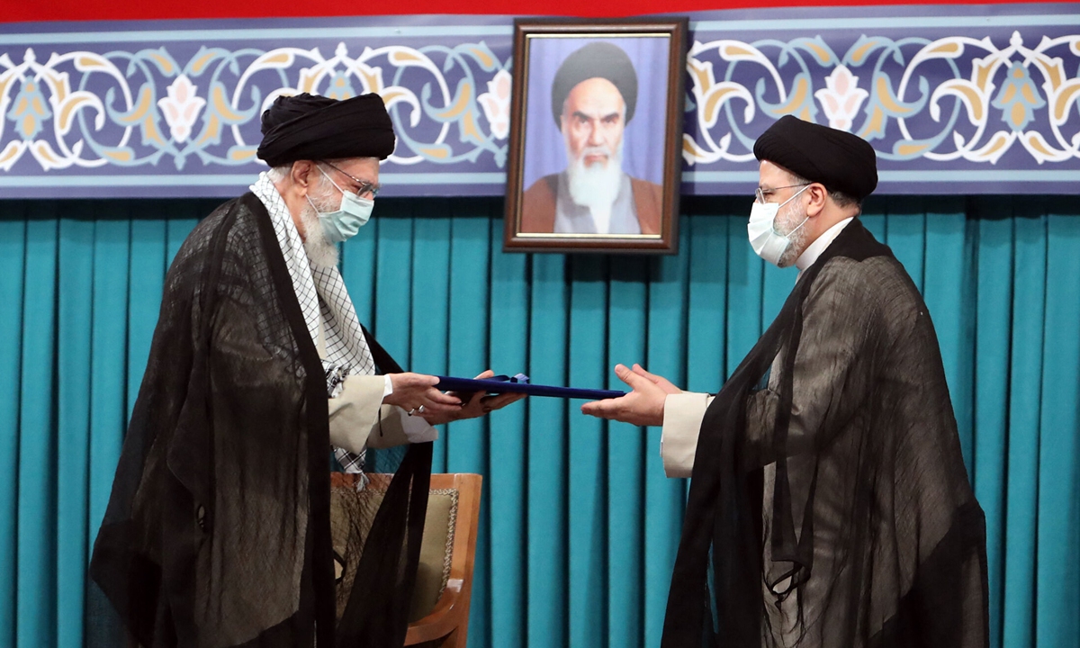 A handout picture provided by the office of Iran's Supreme Leader Ayatollah Ali Khamenei on Tuesday, shows him (left) during the inauguration ceremony for Ebrahim Raisi as President, in Khamenei's office in the capital Tehran. Raisi was inaugurated as president of Iran, a country whose hopes of shaking off a dire economic crisis hinge on reviving a nuclear deal with world powers. Photo: AFP