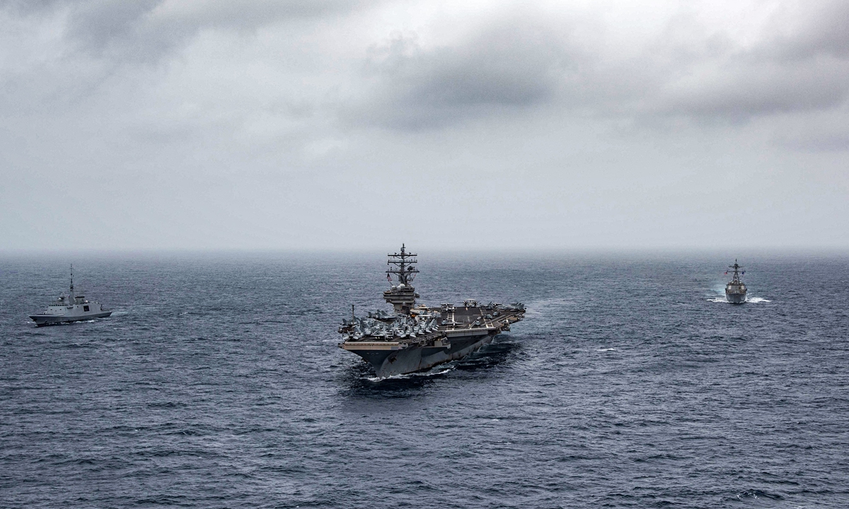 This handout photo courtesy of US Navy, made available on July 24, shows (left to right) French navy frigate <em>FS Languedoc</em>, aircraft carrier <em>USS Ronald Reagan</em>, and guided-missile destroyer <em>USS Halsey</em> steaming in formation in the Arabian Sea. Photo: AFP