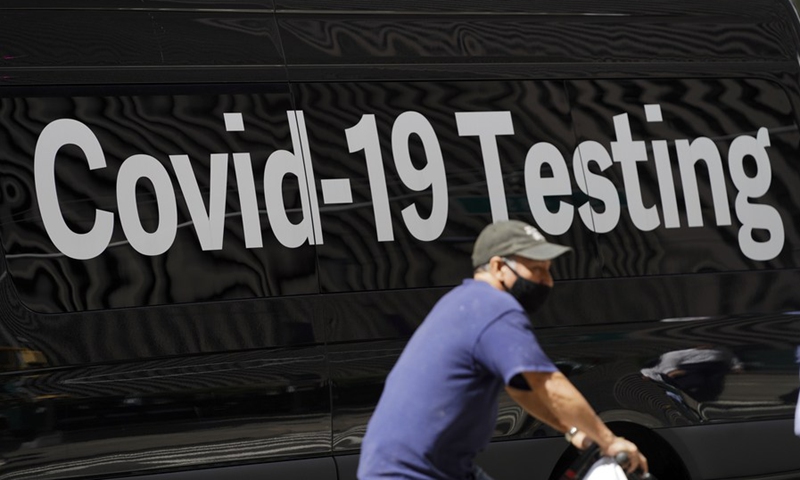 A cyclist rides past a COVID-19 mobile test site in New York City, the United States, Aug. 2, 2021. (Xinhua/Wang Ying)
