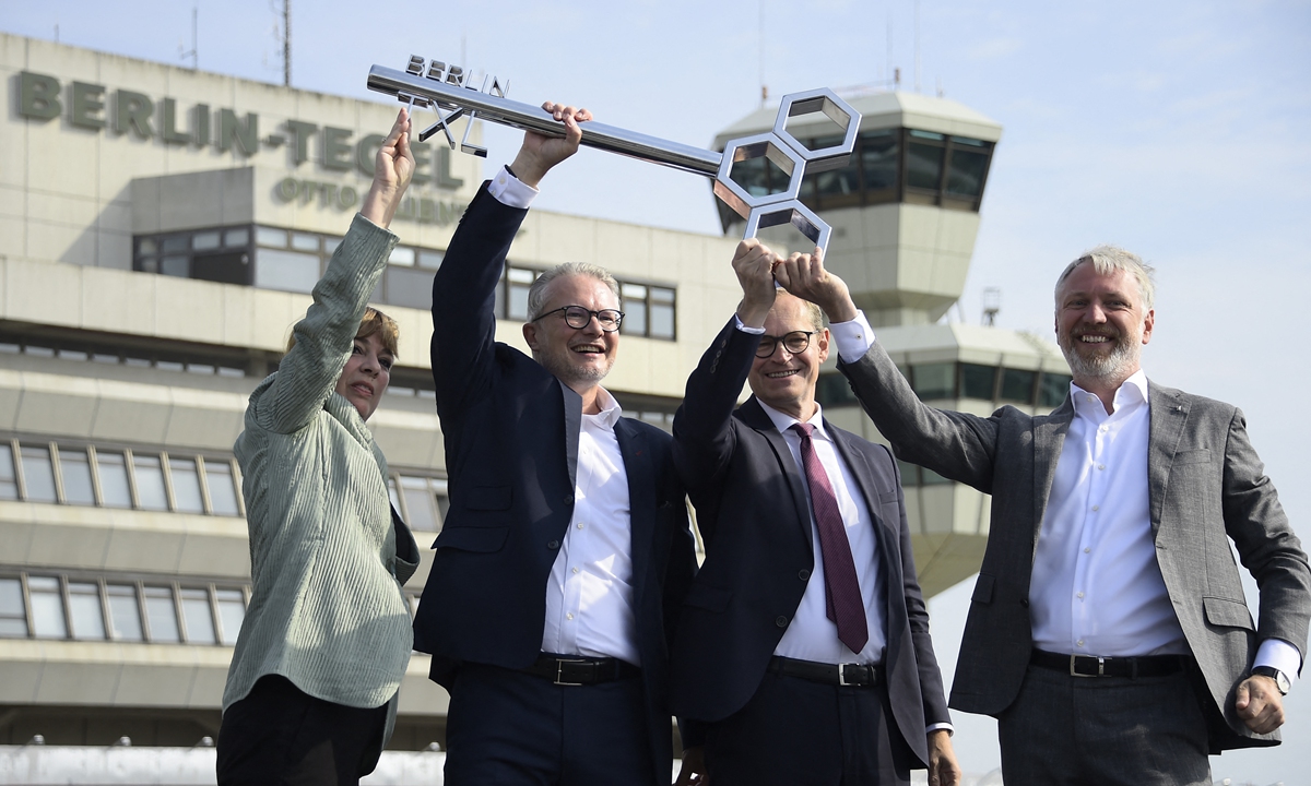 From left: Gudrun Sack and Philipp Bouteiller, leaders of the Tegel Projekt GmbH; Berlin Mayor Michael Mueller and Sebastian Scheel, Berlin's senator for urban development, pose with a symbolic key for the former Tegel airport in Berlin on Thursday, during a ceremony to mark the redevelopment of the airport. Photo: AFP