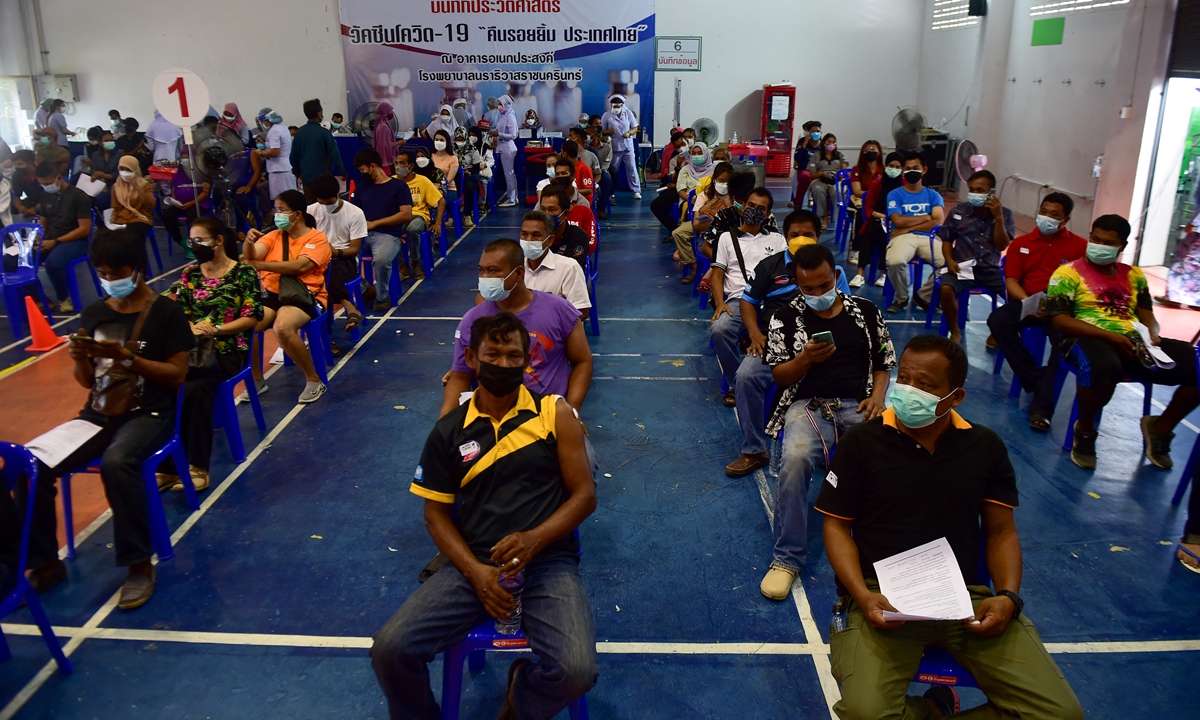 People wait before receiving doses of Sinovac's COVID-19 vaccine at the Narathiwat Hospital compound in the southern province of Narathiwat on Thursday. Thailand reported more than 20,000 new cases on Thursday, making the total infections up to 672,000. Photo: AFP