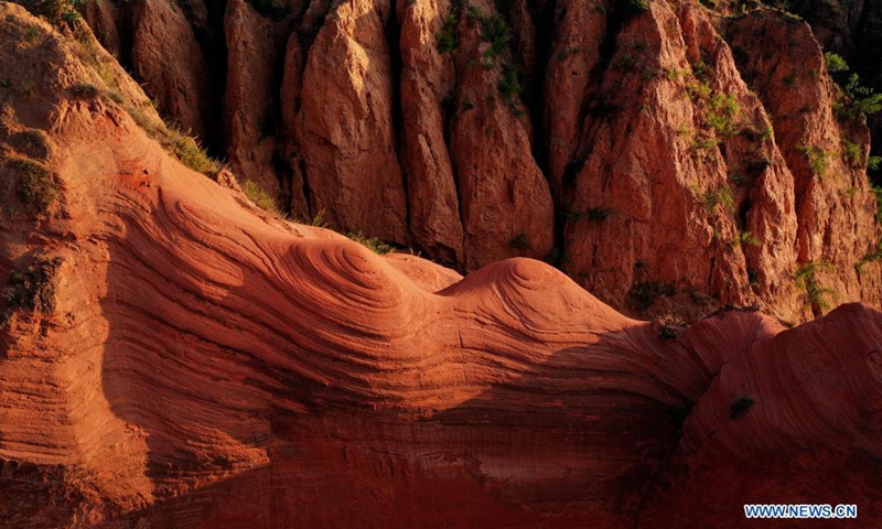 Aerial photo taken on Aug. 6, 2021 shows the Danxia landform, a landscape characterized by reddish sandstone features, in sunrise in Longzhou Town of Jingbian County, northwest China's Shaanxi Province.Photo:Xinhua
