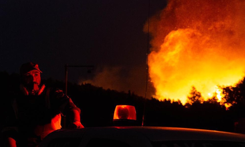 A firefighter tries to put out a wildfire in the north of Athens, Greece, on Aug. 5, 2021.Photo:Xinhua