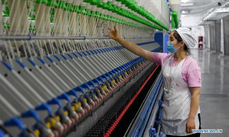 An employee works at a textile factory in Yuli County of Bayan Gol Mongolian Autonomous Prefecture, northwest China's Xinjiang Uygur Autonomous Region, Aug. 24, 2020. Photo: Xinhua