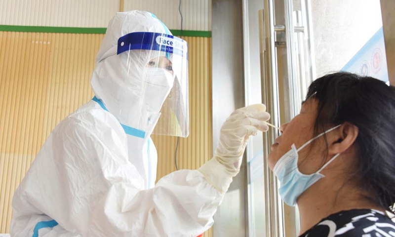A medical worker takes a swab sample for a COVID-19 test at a hospital in Lixian County, central China's Hunan Province, Aug. 5, 2021.Photo:Xinhua