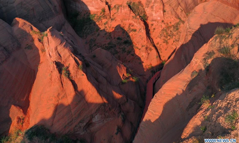 Aerial photo taken on Aug. 6, 2021 shows the Danxia landform, a landscape characterized by reddish sandstone features, in sunrise in Longzhou Town of Jingbian County, northwest China's Shaanxi Province.Photo:Xinhua
