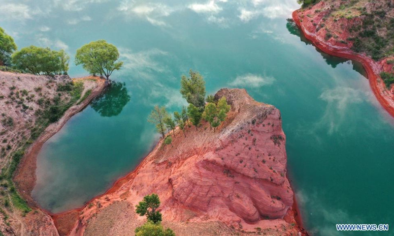 Aerial photo taken on Aug. 6, 2021 shows the Danxia landform, a landscape characterized by reddish sandstone features, in sunrise in Longzhou Town of Jingbian County, northwest China's Shaanxi Province.Photo:Xinhua