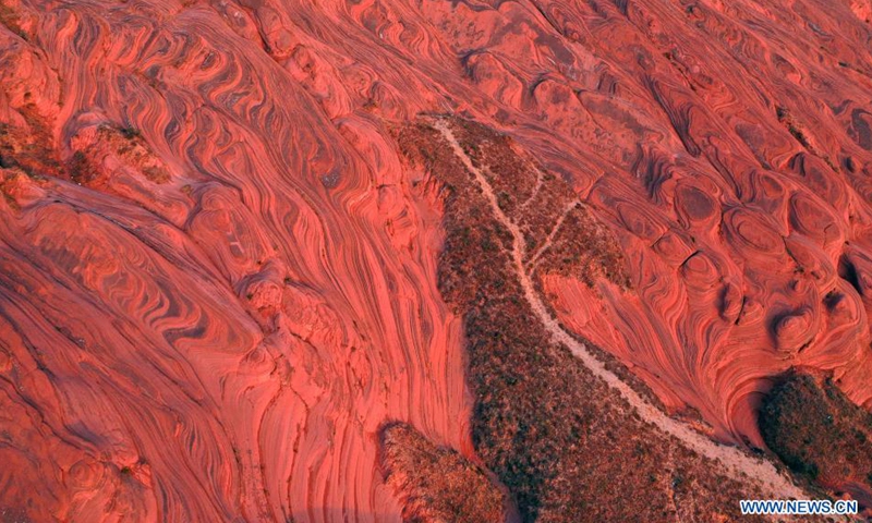 Aerial photo taken on Aug. 6, 2021 shows the Danxia landform, a landscape characterized by reddish sandstone features, in sunrise in Longzhou Town of Jingbian County, northwest China's Shaanxi Province.Photo:Xinhua