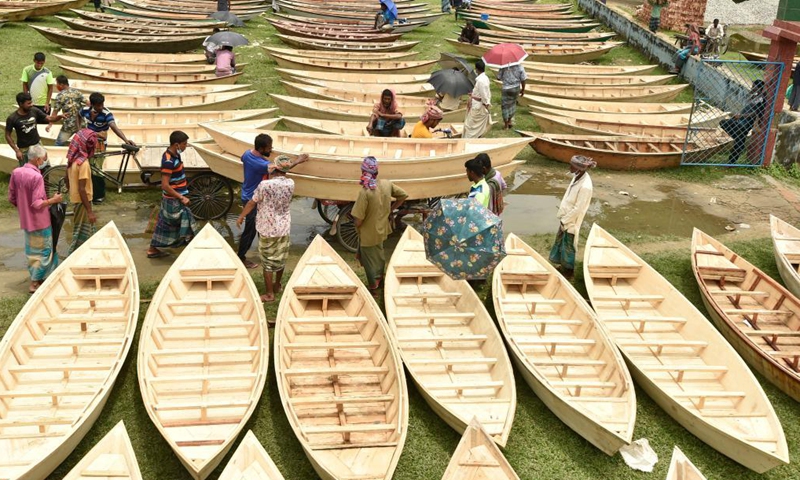 Hand-made wooden boats are displayed for sale at an open-air marketplace in Manikganj district, some 63 km northwest of capital Dhaka, Bangladesh, Aug. 4, 2021. Water transportation is still an important means of communication in some parts of Bangladesh especially during the monsoon season from June to September when sales of traditional small boat increase at the time.Photo:Xinhua