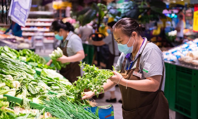 Staff members fulfill customer orders at a supermarket in Yongding District in Zhangjiajie, central China's Hunan Province, Aug. 5, 2021.Photo:Xinhua