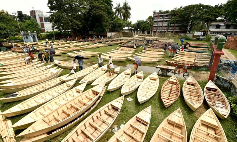 Hand-made wooden boats are displayed for sale at an open-air marketplace in Manikganj district, some 63 km northwest of capital Dhaka, Bangladesh, Aug. 4, 2021. Water transportation is still an important means of communication in some parts of Bangladesh especially during the monsoon season from June to September when sales of traditional small boat increase at the time.Photo:Xinhua