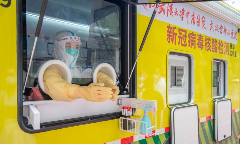 A medical worker works in a mobile lab for COVID-19 nucleic acid testing in Wuchang District of Wuhan, central China's Hubei Province, Aug. 5, 2021.Photo:Xinhua