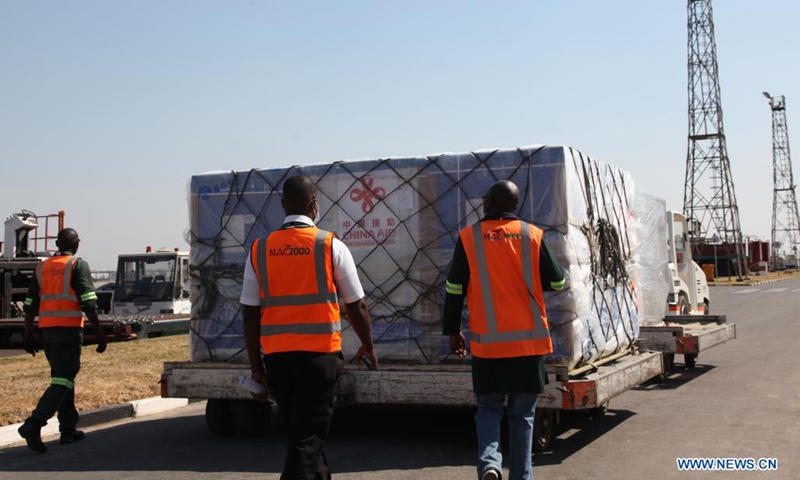 Workers transfer a batch of China's Sinopharm vaccines at the Kenneth Kaunda International Airport in Lusaka, Zambia, on Aug. 7, 2021. A batch of China's Sinopharm vaccines arrived in Zambia on Saturday to be part of the southern African nation's basket of COVID-19 vaccines.(Photo: Xinhua)