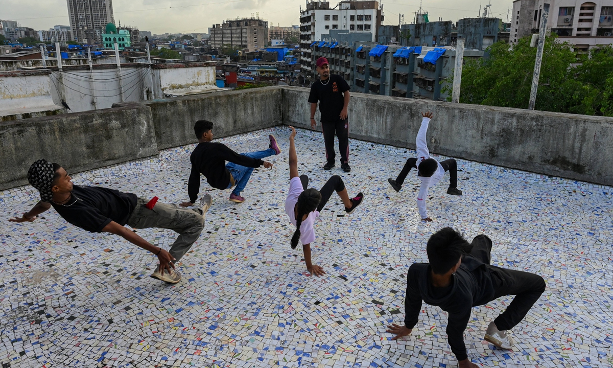 Coach Vikram Godakiya (center) watches students during a group class to learn breaking or 