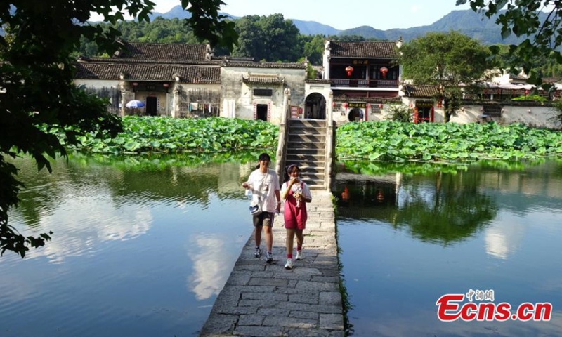 Visitors hang out in the Hongcun village, Huangshan city in Anhui Province, August 8, 2021. (Photo/ Wu Shouyi)