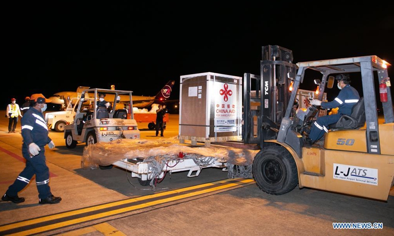 A batch of China-donated Sinopharm COVID-19 vaccines arrives at Wattay International Airport in Vientiane, Laos, Aug. 7, 2021. The fifth batch of China-donated Sinopharm COVID-19 vaccine carried by the Chinese YTO Airlines cargo plane arrived at the Lao capital Vientiane late on Saturday. Lao Health Minister Bounfeng Phoummalaysith and Economic and Commercial Counselor of Chinese Embassy in Laos Zhao Wenyu received the donation at the airport. (Photo by Kaikeo Saiyasane/Xinhua)