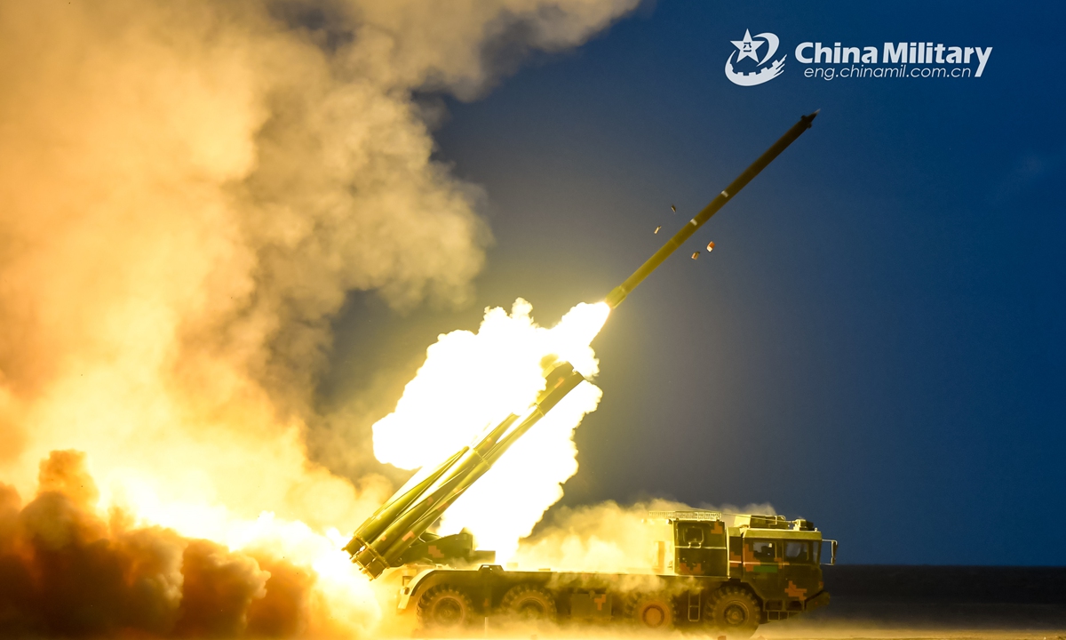 A PHL-03 long-range multiple launch rocket system (LRMLRS) attached to an artillery brigade under the PLA 74th Group Army fires rockets at simulate target during a night raid exercise in an undisclosed desert area of northwest China on July 28, 2021. (eng.chinamil.com.cn/Photo by Huang Hai)