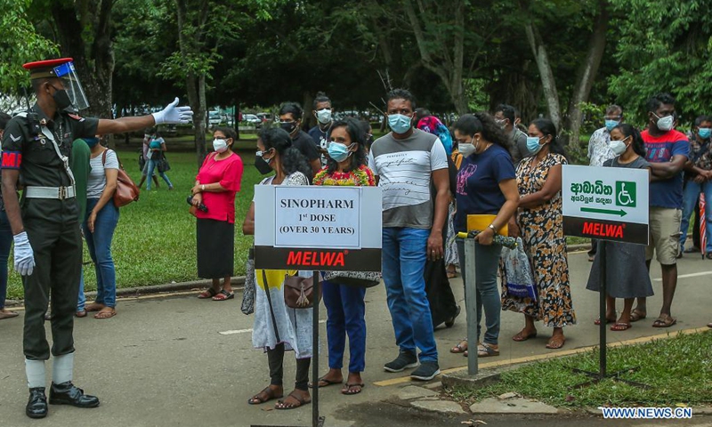 People wait to receive the Sinopharm COVID-19 vaccine in Colombo, Sri Lanka, on Aug. 7, 2021. Sri Lanka is in the midst of a third wave of the COVID-19 pandemic with medical officials warning that the Delta Variant may be spreading beyond control. (Photo: Xinhua)