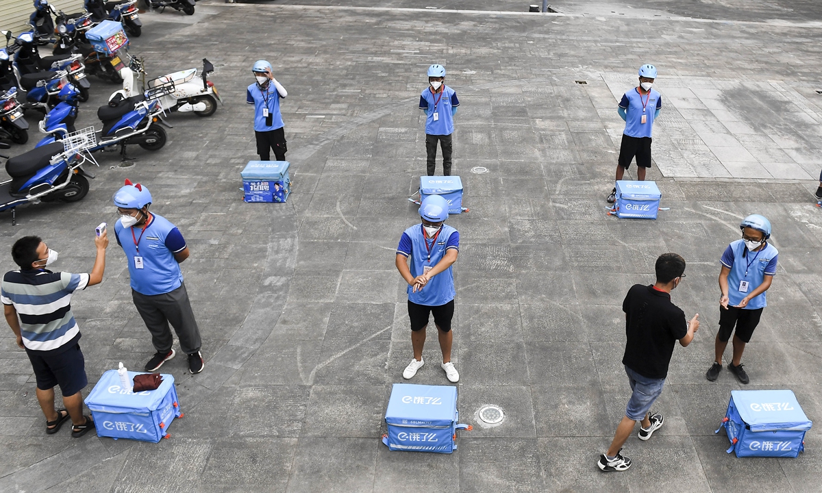 Deliverymen in Zhangjiajie, Central China's Hunan Province undertake daily body temperature testing and disinfection on Monday, before they ride out to carry epidemic-related and daily living goods for local residents in quarantine. The city is among the hardest-hit regions in the latest Delta variant-related outbreak, with 10 new locally transmitted cases being reported on Monday. 
Photo: cnsphoto