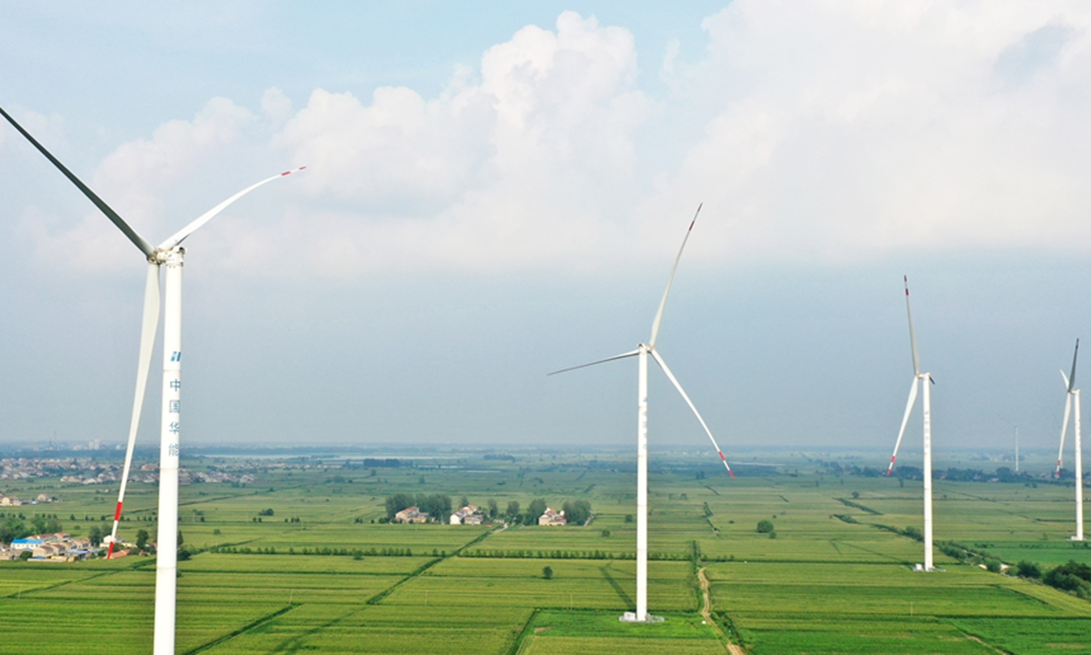 Wind turbines stand among crops in East China's Anhui Province. The Huaneng wind power project, located in Mengcheng county, has a total installed capacity of 200 megawatts and 63 wind turbines. Since June 2020, a total of 432.9 million kilowatt-hours of electricity have been transmitted to the State Grid. Photo: cnsphoto