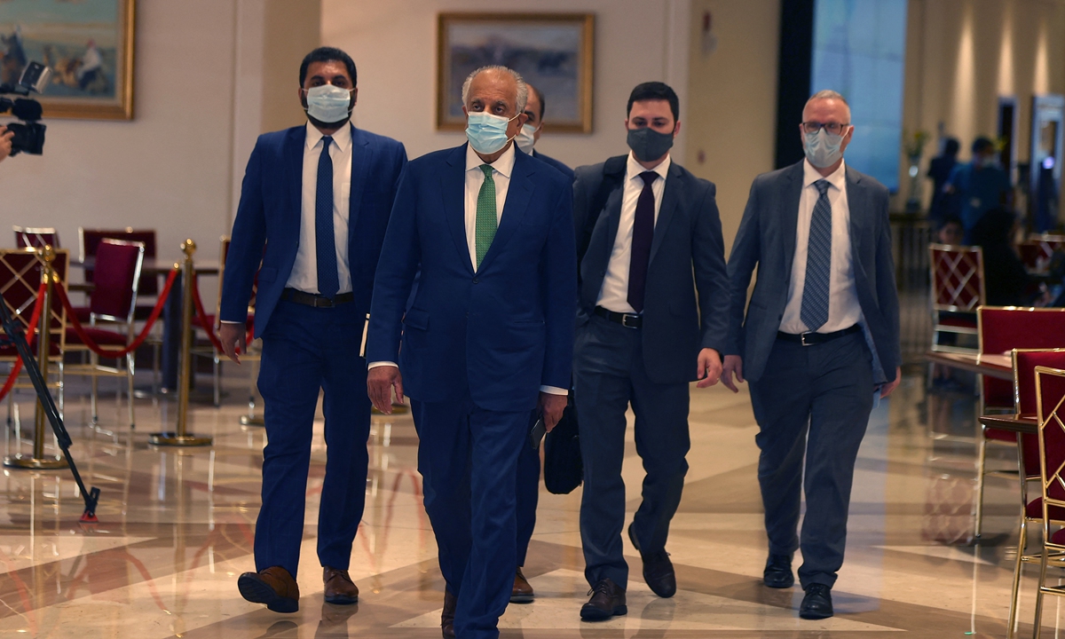 US special envoy to Afghanistan Zalmay Khalilzad (2nd from left) arrives at a hotel in Qatar's capital Doha on Tuesday for an international meeting on the escalating conflict in Afghanistan. The US envoy is in Doha to warn the Taliban not to pursue a military victory on the ground. According to its spokesperson, the Taliban has captured six provincial capitals in the country. Photo: AFP