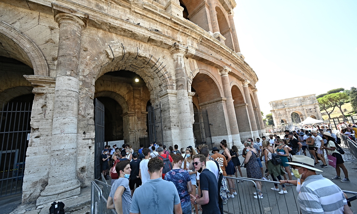 Visitors wait in line before showing their COVID-19 certificates to enter the Ancient Colosseum in central Rome on August 6. Photo: AFP