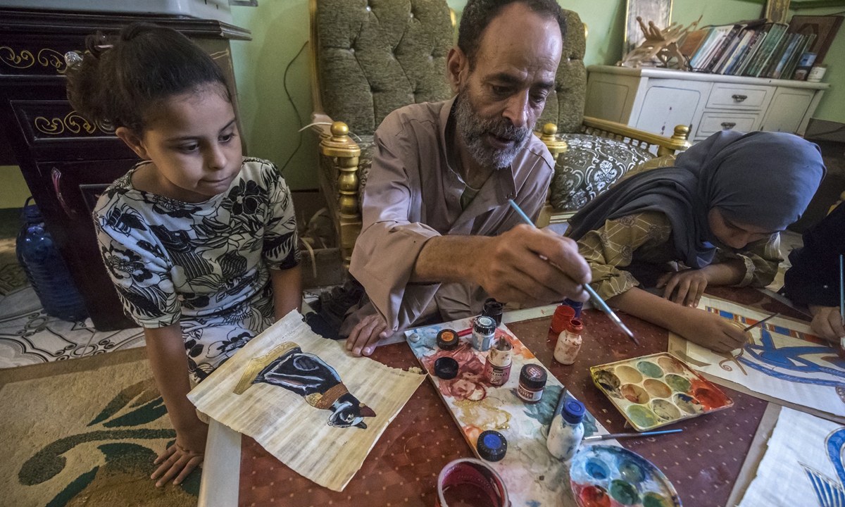 Farmer and painter Said Tarakhan draws on papyrus sheets in the village of Al-Qaramus in Sharqiyah province, Egypt on July 28. Photo: AFP