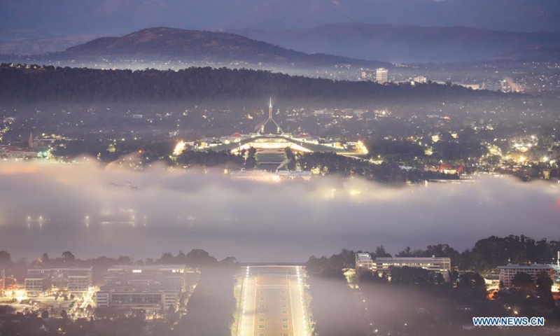 Photo taken on Aug. 15, 2021 shows the Parliament House in thick fog in Canberra, Australia. (Xinhua/Liu Changchang)
