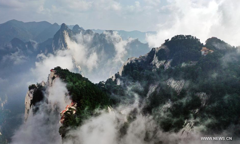Aerial photo taken on Aug. 14, 2021 shows the mist-shrouded Mount Huashan in Weinan City, northwest China's Shaanxi Province. (Xinhua/Tao Ming)