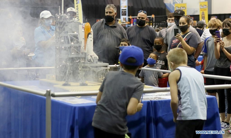 LEGO lovers observe a LEGO art piece during BrickUniverse Lego Fan Festival in Kenner, Louisiana, the United States, on Aug. 14, 2021. BrickUniverse Lego Fan Festival showcased hundreds of LEGO creations from global LEGO artists. (Photo by Lan Wei/Xinhua)
